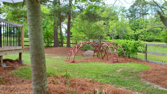 view of play area with fence and a lawn