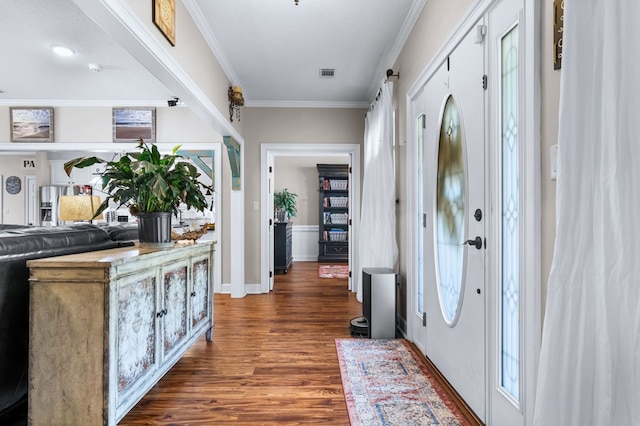 foyer entrance with dark wood-type flooring, visible vents, and crown molding