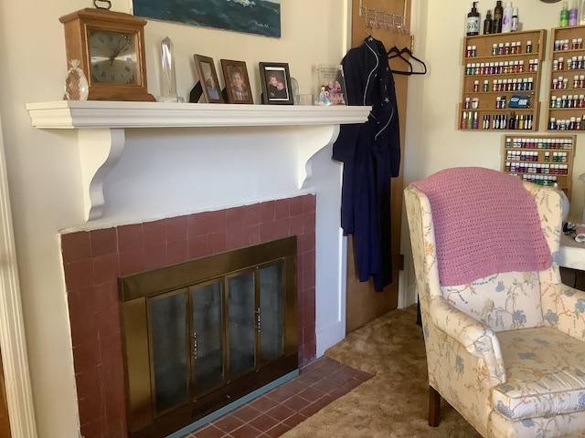 sitting room featuring carpet flooring and a tile fireplace