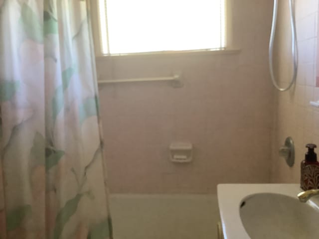 full bathroom with shower / bath combo and a sink