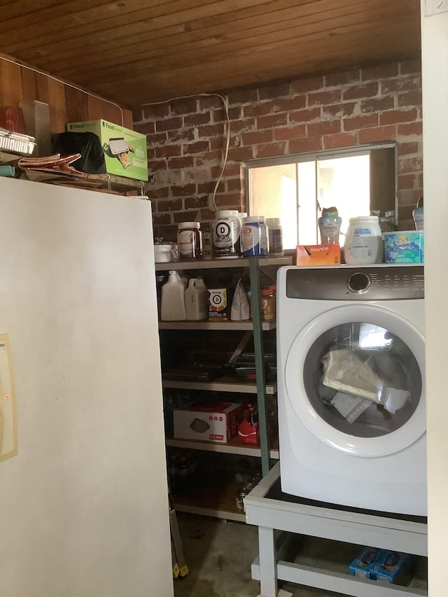 laundry room with washer / dryer, wood ceiling, laundry area, and brick wall