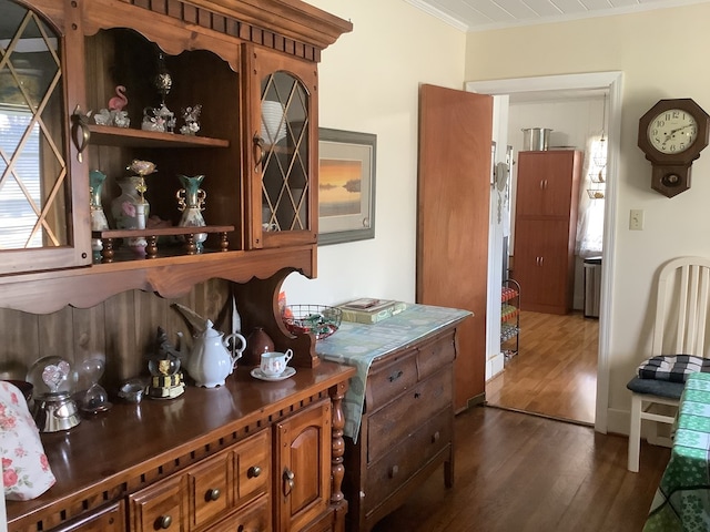 interior space featuring dark wood-type flooring and ornamental molding