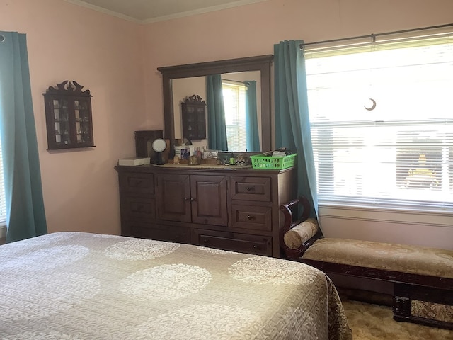 bedroom with multiple windows and crown molding