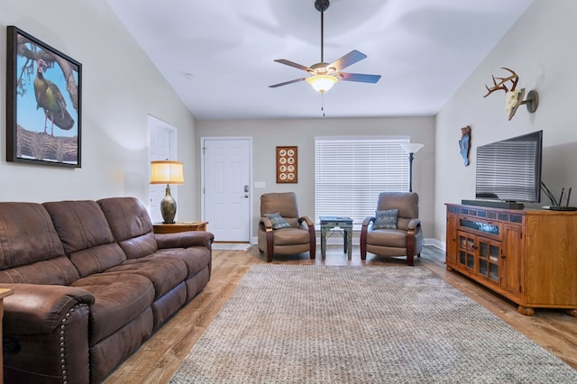 living room with vaulted ceiling, ceiling fan, and light hardwood / wood-style flooring