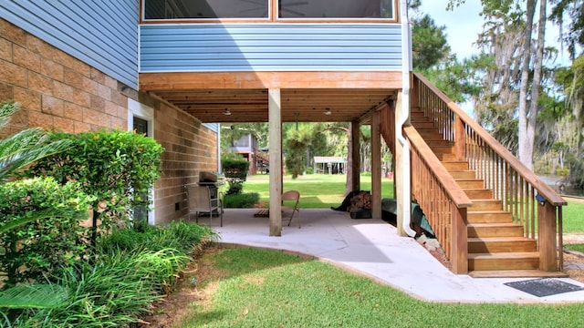 view of patio / terrace featuring a grill and stairs