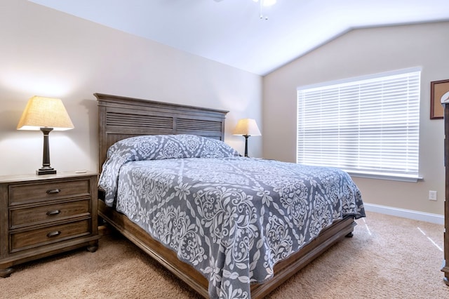 bedroom featuring vaulted ceiling, baseboards, a ceiling fan, and light colored carpet