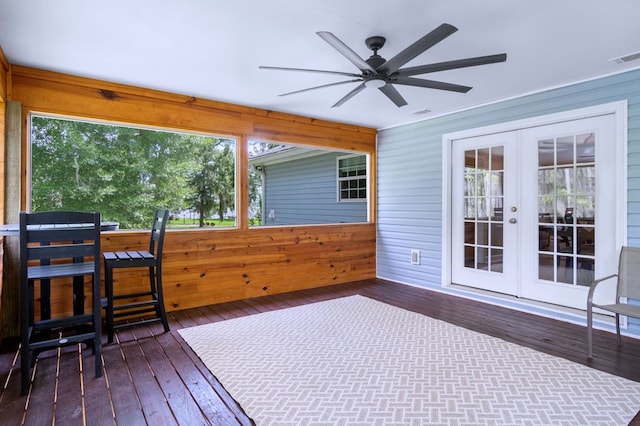 sunroom / solarium featuring ceiling fan, french doors, and visible vents