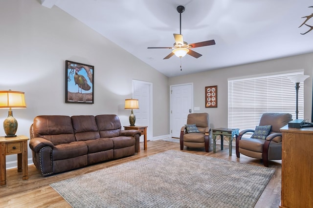 living room with vaulted ceiling, ceiling fan, and light wood-type flooring