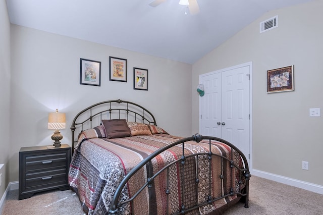 bedroom featuring ceiling fan, a closet, vaulted ceiling, and light carpet