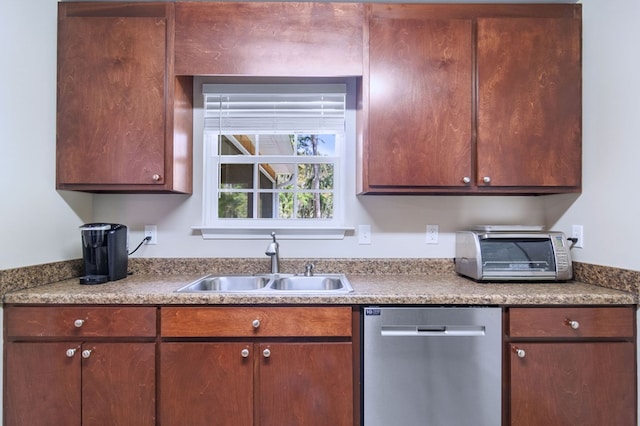 kitchen featuring a sink, a toaster, light countertops, and stainless steel dishwasher