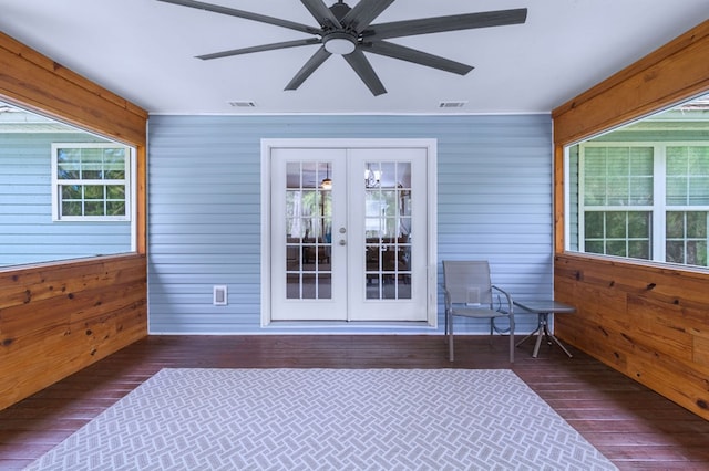 unfurnished sunroom with ceiling fan, visible vents, a wealth of natural light, and french doors