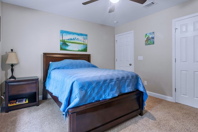 carpeted bedroom featuring ceiling fan, visible vents, and baseboards