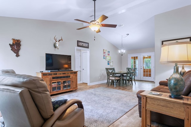 living room featuring ceiling fan with notable chandelier, visible vents, baseboards, french doors, and light wood finished floors