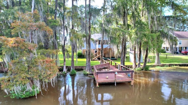 dock area featuring a water view and a yard