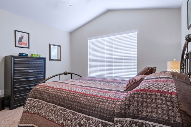 bedroom with carpet floors, vaulted ceiling, and a ceiling fan