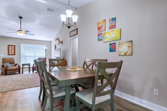 dining area with ceiling fan with notable chandelier, visible vents, baseboards, and wood finished floors