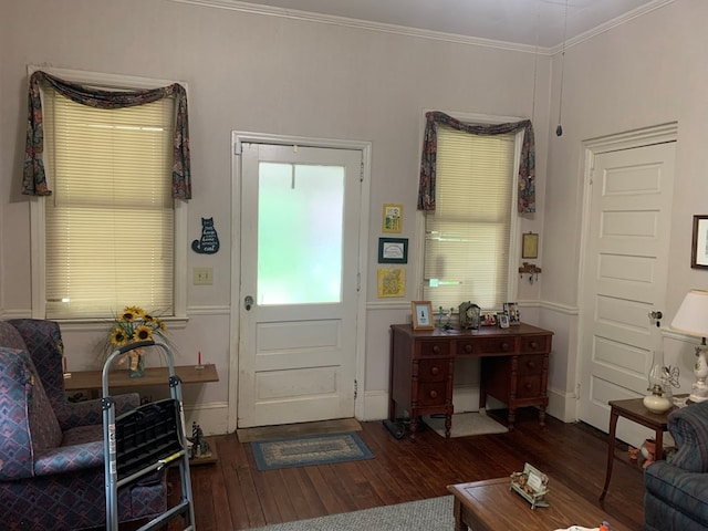 foyer with ornamental molding, wood-type flooring, and baseboards