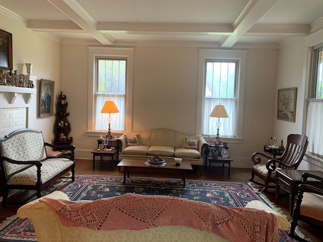 sitting room with baseboards, coffered ceiling, wood finished floors, and beamed ceiling