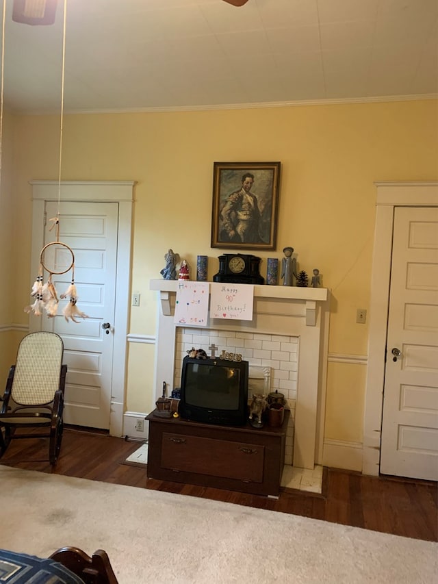 living room with ornamental molding, ceiling fan, and wood finished floors