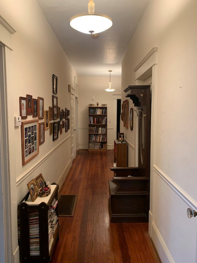 corridor featuring wood-type flooring and visible vents