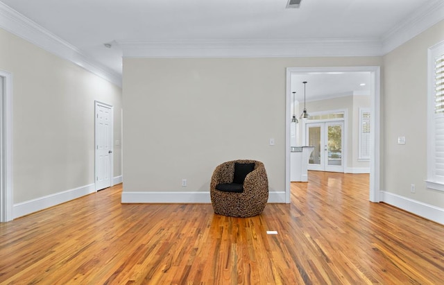 unfurnished room with french doors, ornamental molding, and light hardwood / wood-style floors