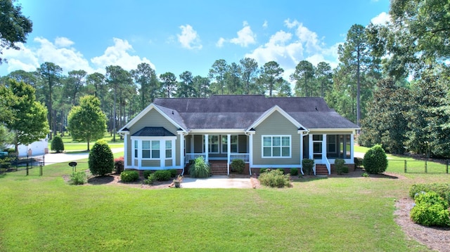 back of house with a sunroom and a yard