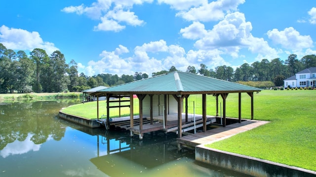 view of dock with a water view and a yard