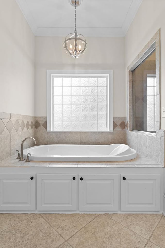 bathroom featuring crown molding, a chandelier, tile patterned flooring, and a tub to relax in