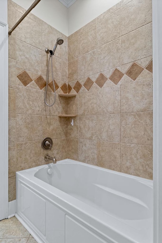 bathroom featuring tiled shower / bath combo and tile patterned flooring