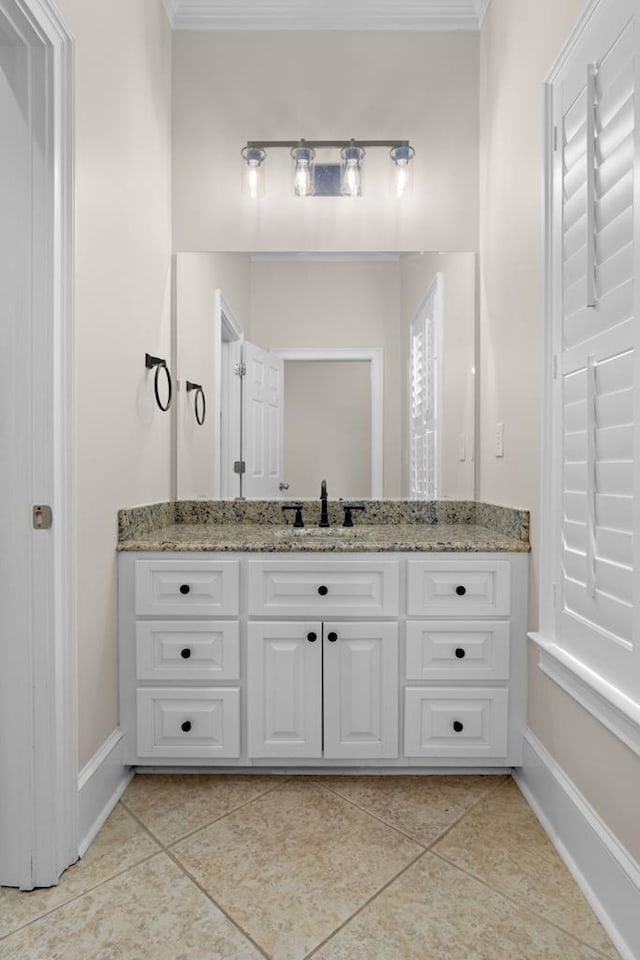 bathroom with ornamental molding, tile patterned floors, and vanity