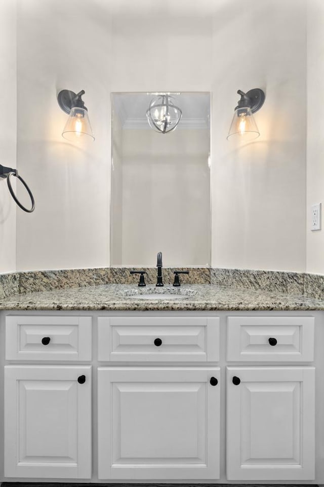 bathroom with vanity and ornamental molding