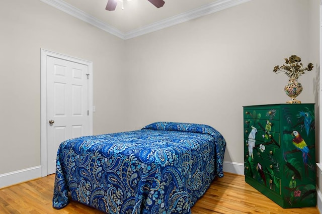 bedroom with crown molding, wood-type flooring, and ceiling fan