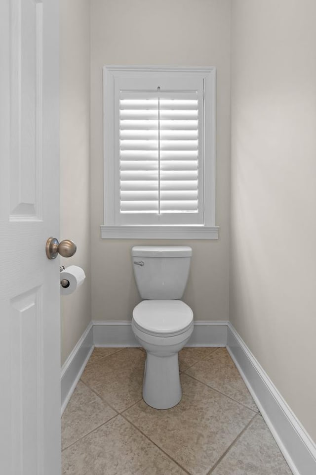 bathroom featuring toilet and tile patterned floors