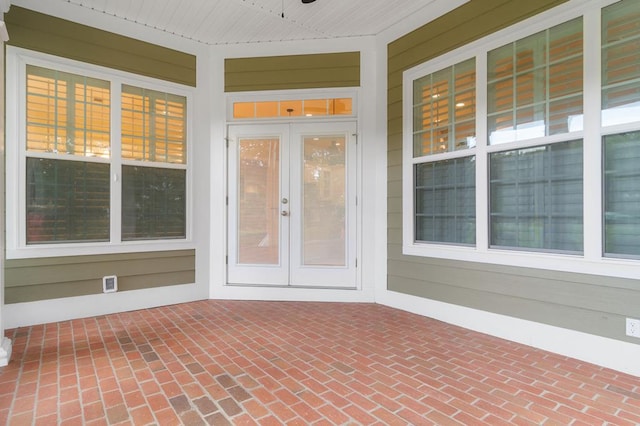 view of exterior entry with a patio area, ceiling fan, and french doors