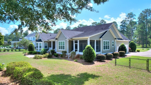 view of front of home with a front yard and a sunroom