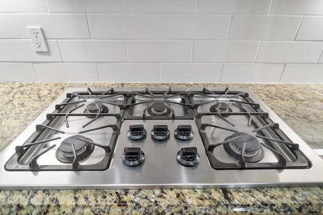 interior details with gas stovetop and backsplash