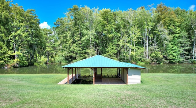 view of community with a gazebo, a water view, and a yard