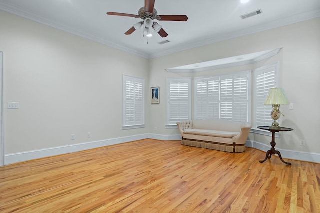 unfurnished room with ceiling fan, light hardwood / wood-style flooring, and ornamental molding