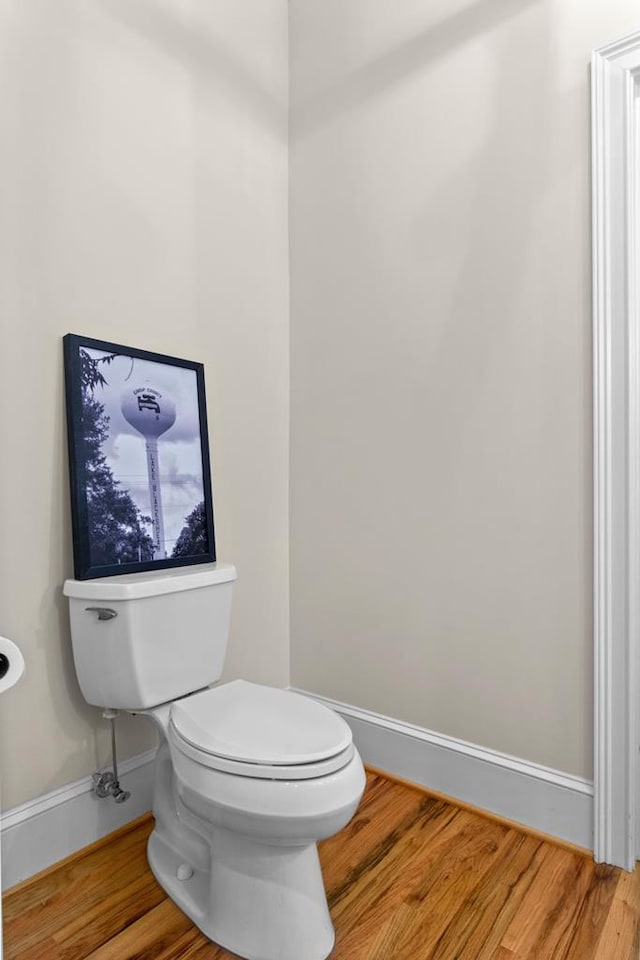 bathroom with hardwood / wood-style flooring and toilet