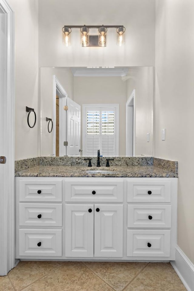 bathroom with tile patterned floors, vanity, and crown molding