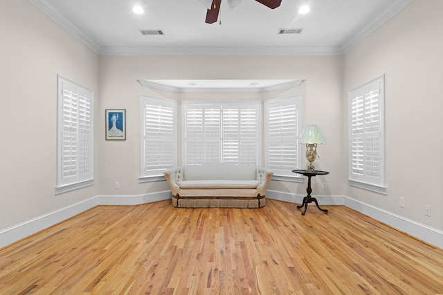 unfurnished room with light hardwood / wood-style floors, ornamental molding, and ceiling fan