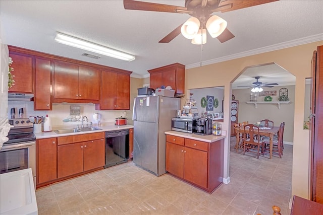 kitchen with ornamental molding, stainless steel appliances, sink, and a textured ceiling