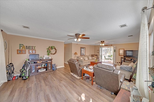 living room featuring ornamental molding, a textured ceiling, and light wood-type flooring