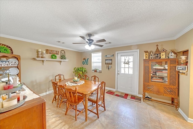 dining room with a textured ceiling, ornamental molding, and ceiling fan