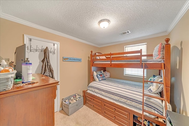 bedroom with light carpet, ornamental molding, and a textured ceiling