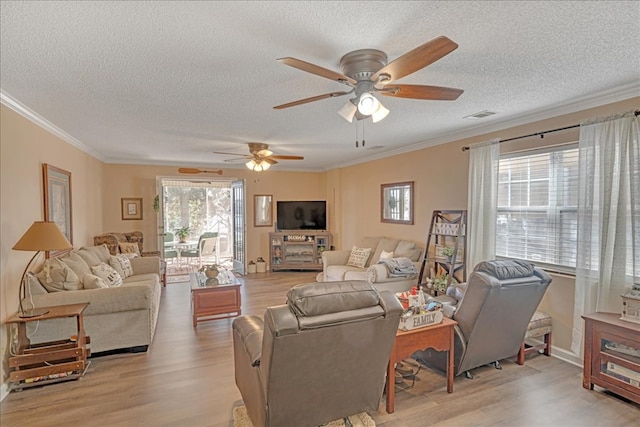 living room with crown molding, a textured ceiling, and light hardwood / wood-style floors