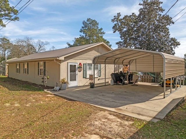 view of car parking featuring a yard and a carport