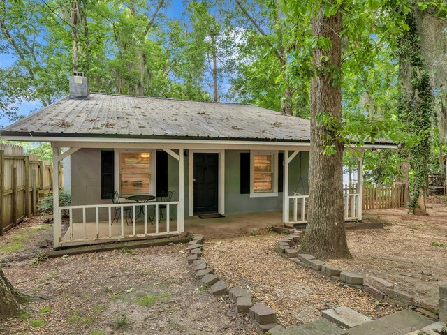 119A-B Tommy Warren Dr, Cobb, GA 31735 - view of front of home featuring covered porch, a chimney, and a metal roof