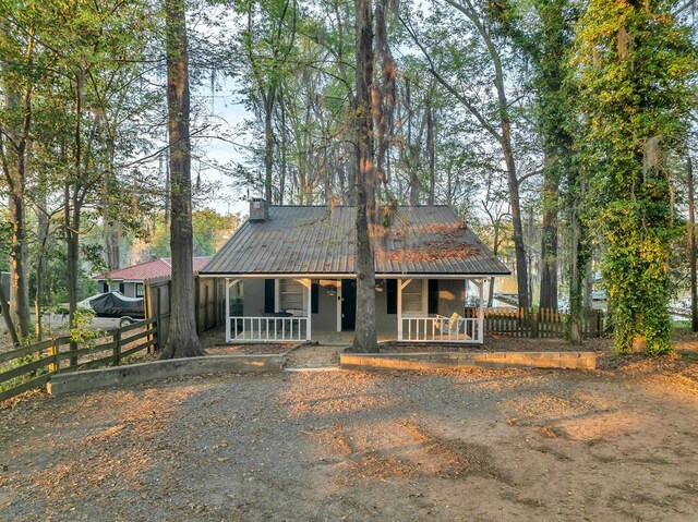 119A-B Tommy Warren Dr, Cobb, GA 31735 - rustic home featuring covered porch, a metal roof, and a chimney