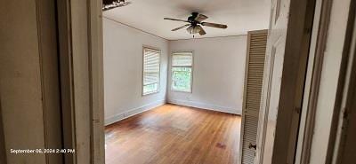 spare room with ceiling fan and wood-type flooring